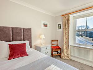 a bedroom with a bed and a window and a chair at 4 Bed in Bishop Auckland oc-93527 in Wear Head