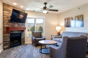a living room with a couch and a fireplace at Massanutten Resort in Massanutten