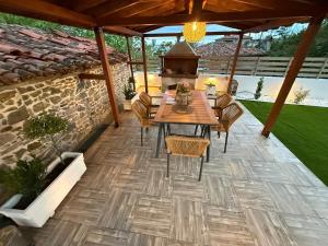 an outdoor patio with a wooden table and chairs at Modern Makri in Makri