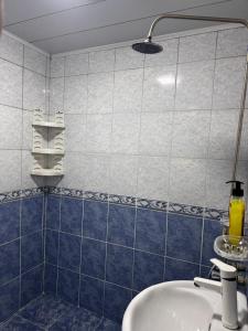 a bathroom with a blue and white tiled wall at Apartment in Lankaran in Lankaran