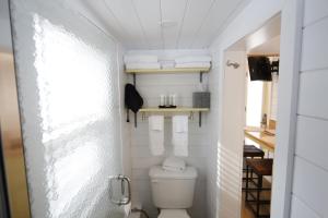 a small bathroom with a toilet and a table at River and Twine in Rocky Mount +5 photos