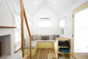 a small room with a bench in a tiny house at River and Twine in Rocky Mount
