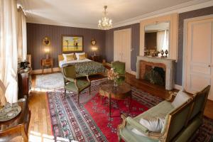 a bedroom with a bed and a living room at Château La Rametière in Le PARC