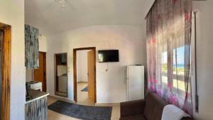 a living room with a couch and a refrigerator at Tropical apartment in Flogita