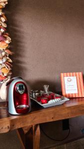a table with a toaster and a plate of food at Maly Boutique Hotel in Fortaleza
