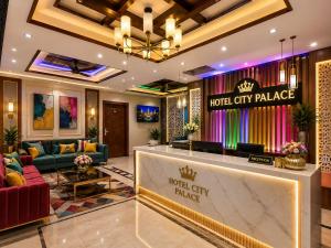 a hotel lobby with a hotel city palace sign at Hotel City Palace in Pānīpat +17 photos
