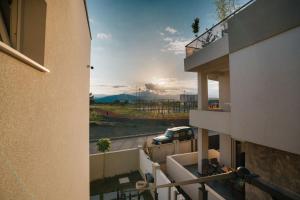 a view from the balcony of a building with a car on the road at Bubbles 2 Apartments in Gevgelija
