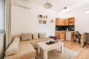 a living room with a couch and a table at Bubbles 2 Apartments in Gevgelija