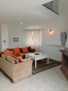 a living room with a couch and a coffee table at Hotel Rural El Vaqueril in Navas del Madroño