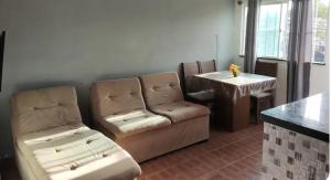 a living room with a couch and a table at Bruno in São José de Ribamar