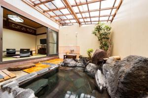 a house with a pond in the middle of it at Koto no Kashin in Yufu