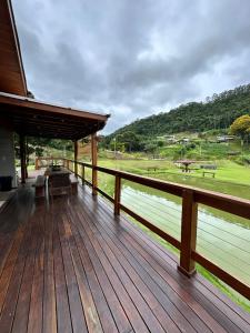 a wooden deck with a view of a park at Rancho Nosso Lago in Domingos Martins