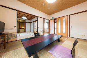 a conference room with a black table and chairs at Koto no Kashin in Yufu