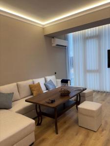 a living room with a couch and a coffee table at Jamshed apartment in Samarkand