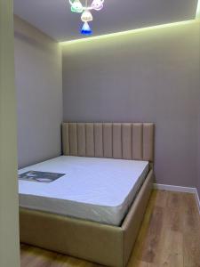 a bedroom with a bed in a room at Jamshed apartment in Samarkand