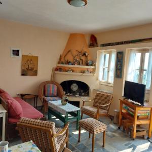 a living room with a couch and a fireplace at Sunrise house Alonnisos in Alonnisos