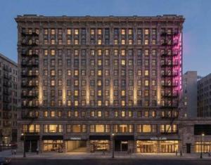 a large building with a pink light on it at Hotel Clark in Los Angeles