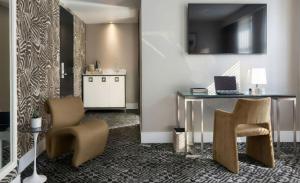 a office with a desk and two chairs and a laptop at Hotel Clark in Los Angeles