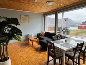 a living room with a couch and a table at Fjord Guesthouse in Súðavík
