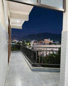 a balcony with a view of a city at night at Hotel Badri Palace in Rishīkesh