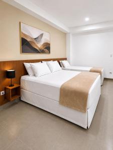 a large white bedroom with a large white bed at Smart Hotel GRU in Guarulhos +38 photos