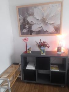 a black desk with a picture on the wall at Chambre chez Danuta in Champagnole +1 photo