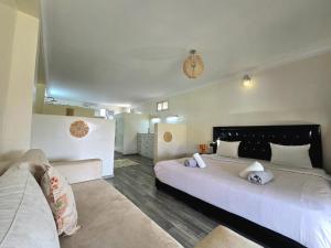 a bedroom with two beds and a couch at Admylla in Sraghna +24 photos