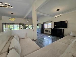 a living room with a couch and a flat screen tv at Admylla in Sraghna