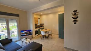 a living room with a couch and a table at Estia Chios Apartments B6 in Chios