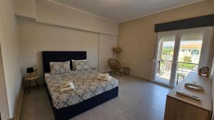 a bedroom with a bed with towels on it at Estia Chios Apartments B6 in Chios