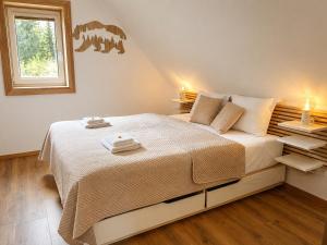 a bedroom with a bed with two towels on it at Chalupa pod Špičákem in Smržovka