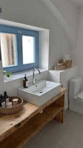 a bathroom with a white sink and a window at Pod Borovicí Broumy in Broumy