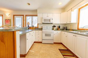 a kitchen with white cabinets and white appliances at Fun 'N Sun - Nags Head MP 16, 250 Ft to Beach Access, Pool, Pets OK, YR Flex Stays in Nags Head