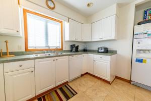 a kitchen with white cabinets and a window at Fun 'N Sun - Nags Head MP 16, 250 Ft to Beach Access, Pool, Pets OK, YR Flex Stays in Nags Head +51 photos