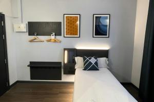 a bedroom with a bed and three pictures on the wall at Four Points Flex by Sheraton Malaga Centre in Málaga +25 photos
