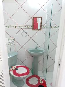 a small bathroom with a sink and a toilet at Pousada Aconchego dos Puris in Resende +29 photos