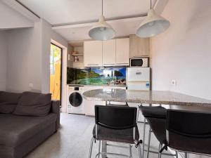 a kitchen and living room with a table and chairs at Fuerte premium blue in Costa Calma