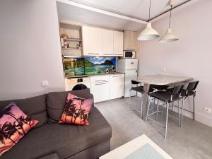 a living room with a couch and a table and a kitchen at Fuerte premium blue in Costa Calma +6 photos