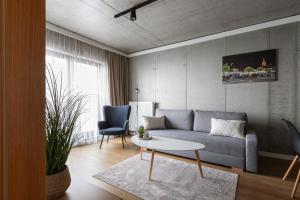 a living room with a couch and a table at River Side Apartments in Oświęcim