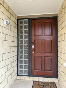 a brown door with glass windows on a house at Duke St Townhouse in Cambridge