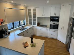 a kitchen with white cabinets and a counter top at Duke St Townhouse in Cambridge