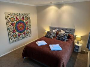 a bedroom with a bed with two towels on it at Duke St Townhouse in Cambridge +7 photos