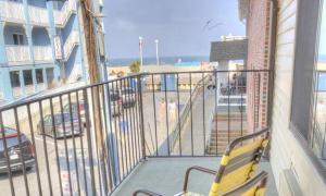 a balcony with a yellow bench and a view of the beach at Eden Roc Downtown in Ocean City