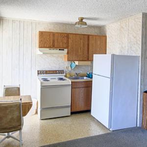 a kitchen with a white refrigerator and a sink at Eden Roc Downtown in Ocean City