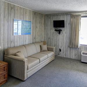 a living room with a couch and a television at Eden Roc Downtown in Ocean City
