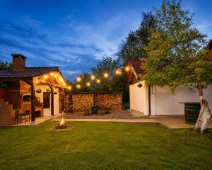 a backyard with lights on the side of a house at Serenity Garden Villa in Runcu +84 photos