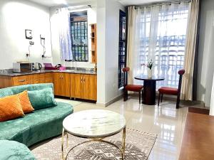 a living room with a couch and a table at Luxury Ntinda Apartment with Wi Fi and Netflix in Kampala