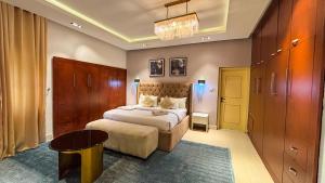 a bedroom with a bed and a table in it at Mac Residence in Lagos