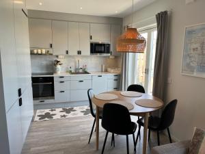 a kitchen with a table and chairs in a room at Järvsö Kramstatjärnsvägen 10E in Järvsö