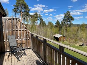 a chair on the deck of a cabin at Järvsö Kramstatjärnsvägen 10E in Järvsö